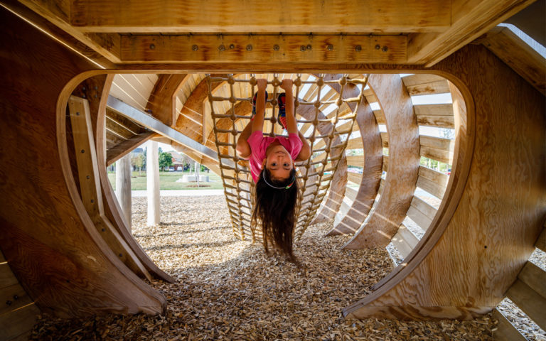 girl hangs upside down Richmond Hill playground