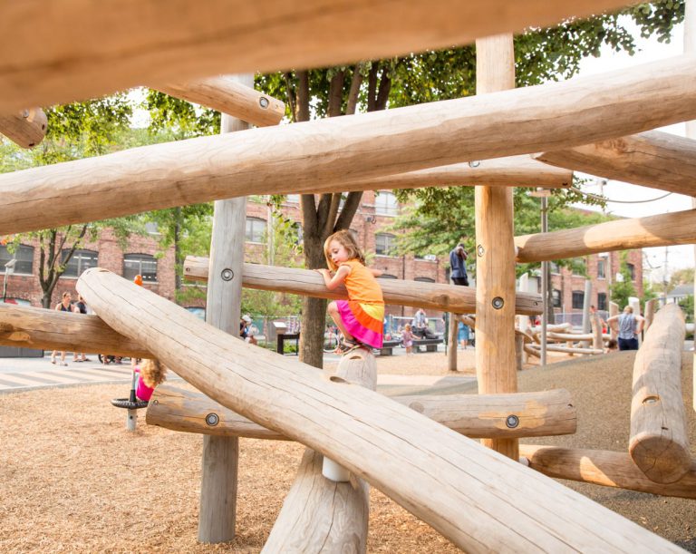 Child playing on wooden playground