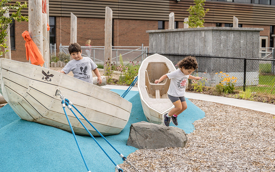 MCNF canoe sculptures and boulder with children playing