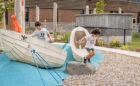 MCNF canoe sculptures and boulder with children playing